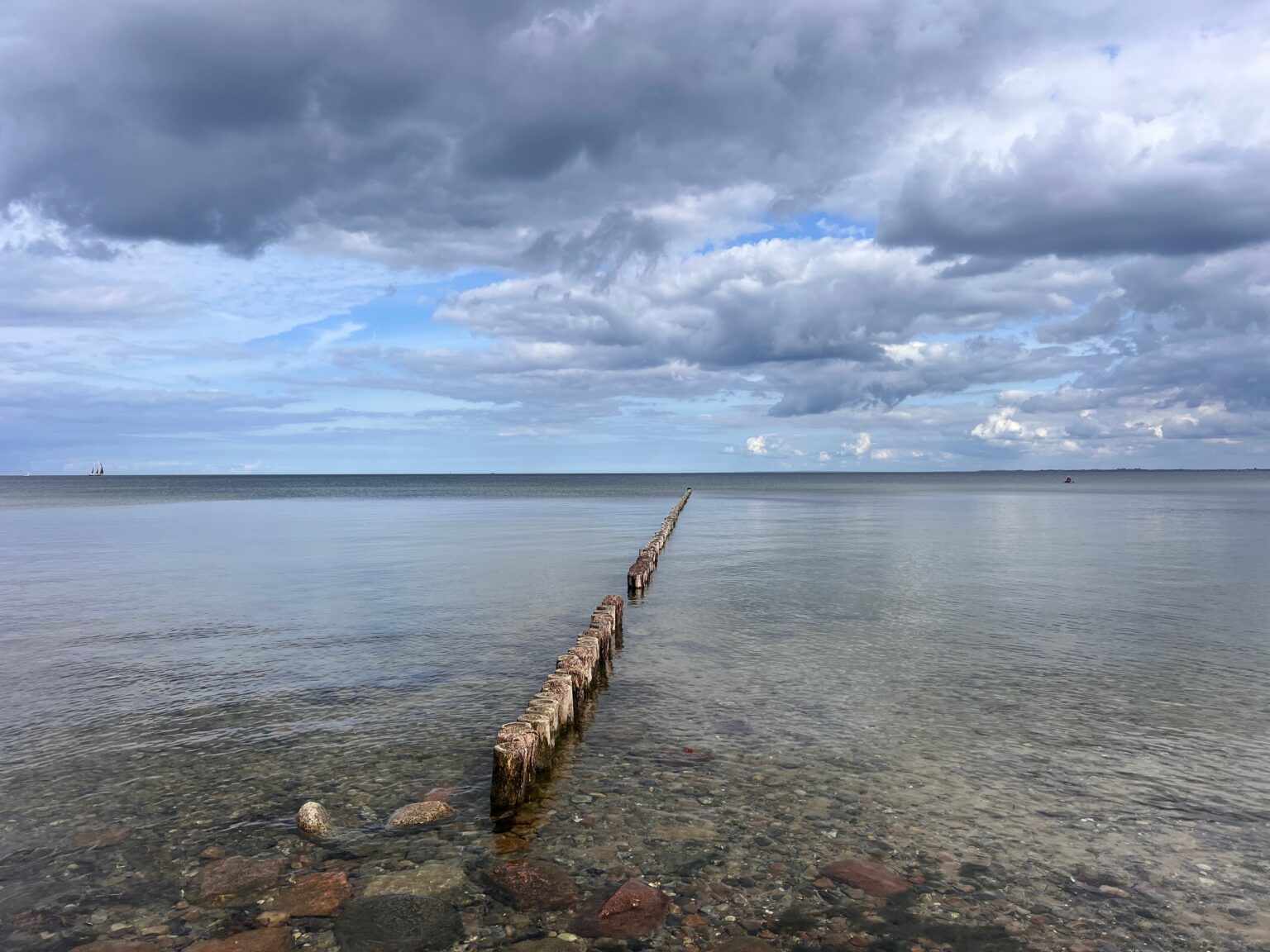 Ostseeküste mit Buhnen und weitem Horizont
